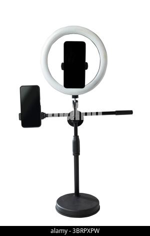 Round LED ring light with a cellphone on a phone holder isolated over a white background. Vlogging or live streaming equipment. Mockup or Copy space Stock Photo