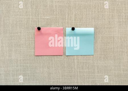 pinned blank post it note on cork board background Stock Photo