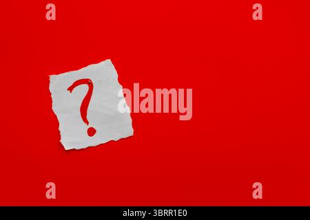 Red Question mark on white paper background, question mark ? symbol isolated on red background Stock Photo
