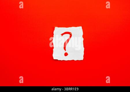 Red Question mark on white paper background, question mark ? symbol isolated on red background Stock Photo