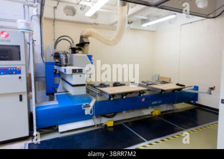 3D render showing blue CNC milling machine is working in workshop with dust hose, control console Stock Photo