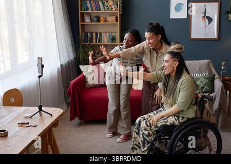Diverse Young Adult Women Dancing Together with Disability during Video Recording Stock Photo