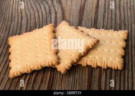 Dried biscuits pile  isolated on wood background Stock Photo