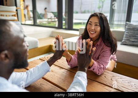Joyful African-Asian couple embracing their diverse backgrounds, celebrating togetherness, identity Stock Photo