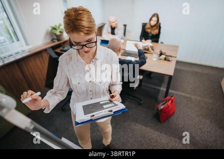 Business colleagues engaging in collaborative meeting within modern office space Stock Photo