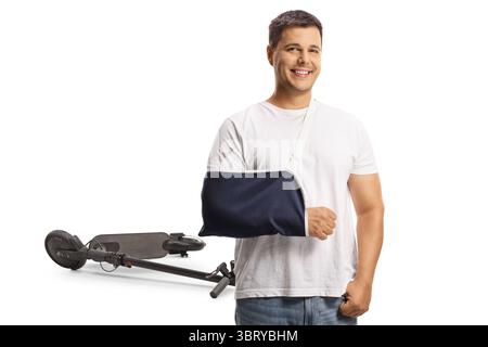 Young man with a broken arm injured in a scooter accident isolated on white background Stock Photo