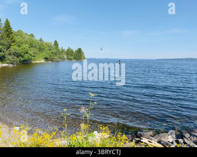A beautiful summer day on a tranquil lake with clear blue skies and serene waters. Stock Photo