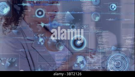 Interacting professional woman holding hand up in corporate office, with floating HUD graphics Stock Photo