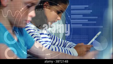 Viewing classmates in blue and striped shirts using tablets in classroom, with digital data visuals Stock Photo