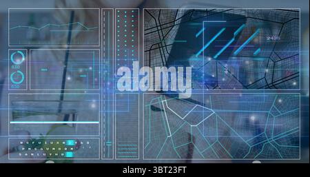 Displaying digital dashboard overlay above laptop on desk in office, with holographic data panels Stock Photo