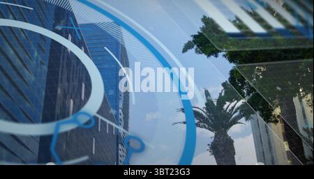 Displaying digital HUD overlay floating over skyline downtown, with glass skyscraper and palm trees Stock Photo