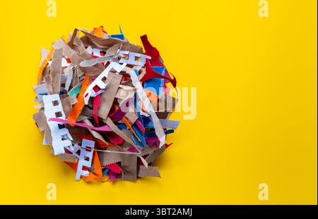 pile of paper waste isolated on background, shredded paper strips on a yellow background, Recycle Paper background Stock Photo