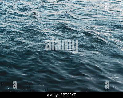 Textured water wave surface in natural daylight, HD water waves with ripples detail Stock Photo