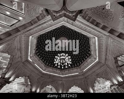 Mosque interior showcasing Islamic geometric art, chandelier, and Moroccan dome design Stock Photo