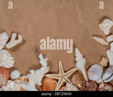 Beach themed flat lay with shells and starfish on natural linen fabric Stock Photo
