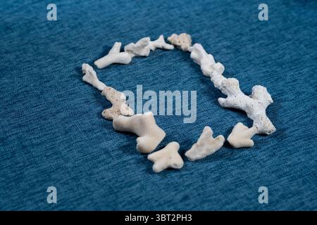 Coastal summer background with seashells and starfish on blue textured fabric Stock Photo