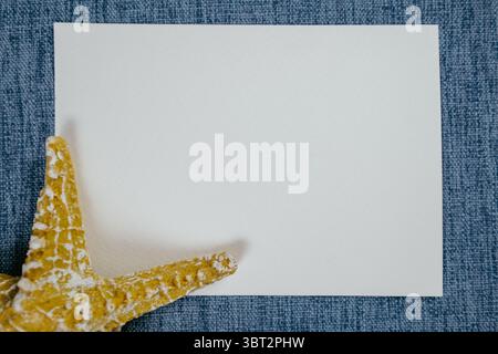 Empty blue fabric frame with starfish and beach themed minimal background Stock Photo
