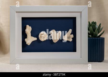 Beautiful Handmade Coral Art Frame Spelling LOVE – Perfect Valentine’s Day Gift Stock Photo