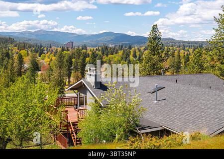 View from a mid century hillside home of McEuen Tower in downtown and the hills of the city of Coeur d'Alene, Idaho, from the Fernan Lake area. Stock Photo
