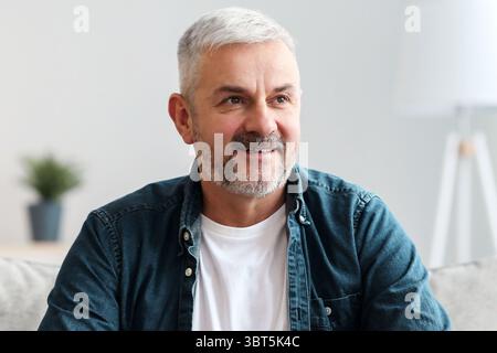 Happy old man with mug looking at copy space Stock Photo