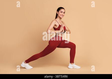 Sporty yogi woman stretching legs doing warmup Stock Photo