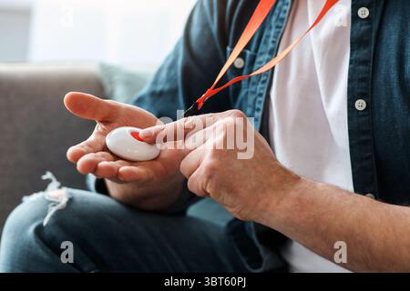 Hand pushing panic button on emergency equipment for old people Stock Photo