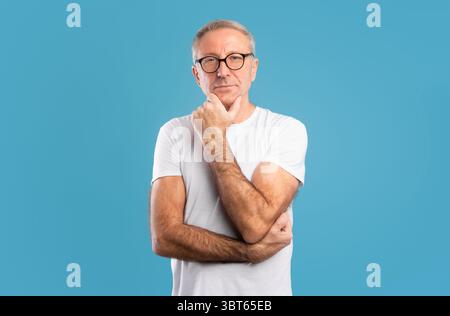 Portrait of pensive mature man looking at camera Stock Photo