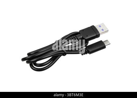 Black USB-A to USB-C charging cable coiled and ready for use. Stock Photo