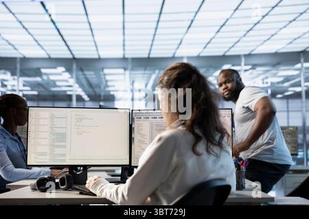 Computer scientist in data center office uses artificial intelligence neural networks doing computing processes. IT specialist working on PC with AI machine learning algorithms Stock Photo