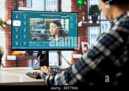 Graphic editor at workstation arranging interface elements in PC ...