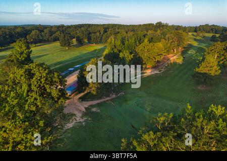 The early morning sun casts some long shadows on the fairways of a golf course in Alabama. Stock Photo