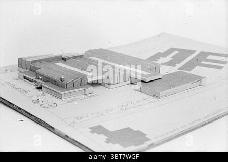 Model Daffodil warehouse office and collection warehouse, Whizgle News, Dutch Desk, The Netherlands, 1950 - 2000 in 1972. These topics are shown in the image. The scene features a meticulously crafted architectural model, resting atop a flattened drawing sheet. The model consists of geometric shapes, predominantly rectangular forms representing various buildings. These forms have a simplified and abstract appearance, hinting at the layout of a larger structure. The color palette is monochromatic, primarily showcasing shades of gray and white, lending a timeless quality to the scene. Each build Stock Photo