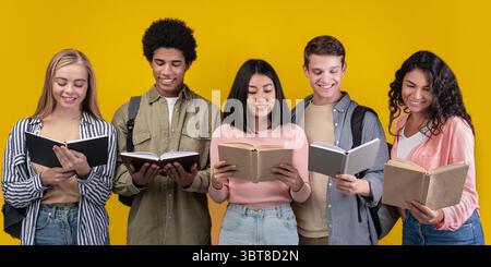 Happy young university students studying with books in library Stock Photo