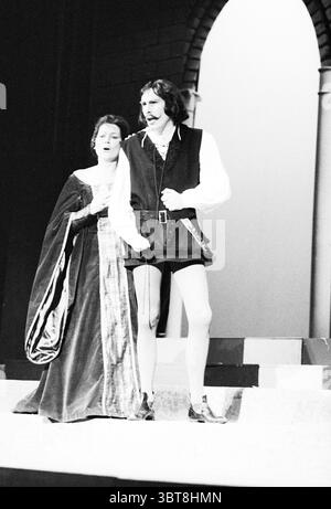 Opera: Il Pirata Bellini Opera operetta, Whizgle News, Dutch Desk, The Netherlands, 1950 - 2000 on 09-11-1977. These topics are shown in the image. The scene depicts a dramatic moment in a theatrical performance, captured in black and white, which enhances the emotional intensity. Two figures dominate the stage: a woman and a man, both dressed in period attire that suggests a historical or classical setting. The woman stands slightly behind the man, her expression conveying a mix of concern and longing. She wears a rich, flowing gown that cascades around her feet, the fabric dark with intricat Stock Photo