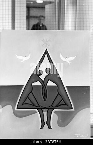 Painting International Christmas card at the Municipality of Zandvoort Zandvoort, Whizgle News, Dutch Desk, The Netherlands, 1950 - 2000 on 24-11-1996. These are the topics in the image. The scene features a striking piece of artwork that captures a blend of abstract forms and symbolic elements. The central figure is a triangular shape, predominantly composed of dark shades that contrast sharply with the lighter background. This triangular figure appears to be seated, with two curled forms representing arms. Above this central shape, two white doves are depicted, gracefully hovering against a Stock Photo