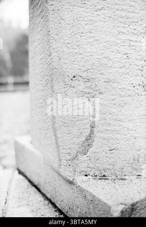 Hildebrand monument + damage Monuments Haarlem The Netherlands, Whizgle News, Dutch Desk, The Netherlands, 1950 - 2000 on 11-06-1981. These are the elements in the image. The scene features a close-up view of a textured stone pillar, characterized by its rough, grainy surface. The pillar stands robustly, hinting at strength and permanence, while its subtle shades of gray and white provide a muted aesthetic. Light plays gently across the surface, creating soft shadows that enhance the three-dimensionality of the stone. A faint outline, possibly a weathered engraving or a natural imperfection, w Stock Photo