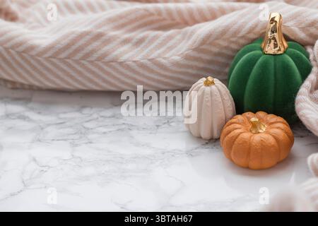Minimalist autumn flat lay with marble texture, elegant fall pumpkins, and cozy textile accents, suitable for lifestyle marketing or product backdrops Stock Photo