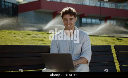 Happy Caucasian man using laptop computer pc programmer smile businessman technology distant work online freelancer positive employee male guy Stock Photo
