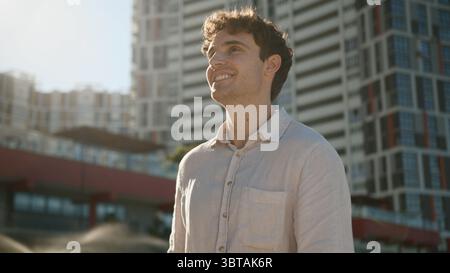 Caucasian young man walking going street successful handsome confident entrepreneur male guy businessman business city outdoors student smiling Stock Photo