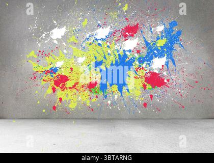 Splashes of color on grey wall Stock Photo