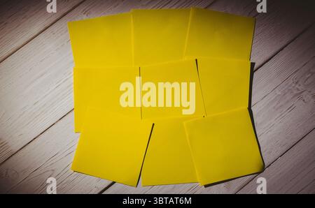 Yellow papers on wooden floor Stock Photo
