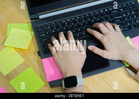 Business people discuss and plan creative work with laptop, making notes on paper stickers and use the post it for new ideas. Stock Photo