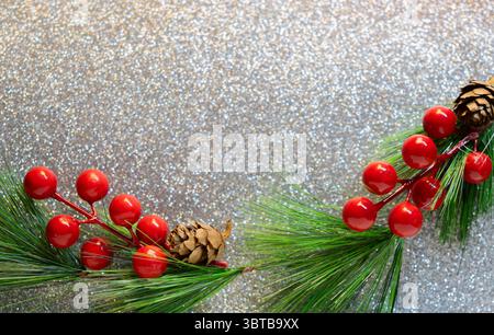 Pine cones and branches on the sparkling glittering silver background. Chirstmas ornament, Christmas and new year background Stock Photo