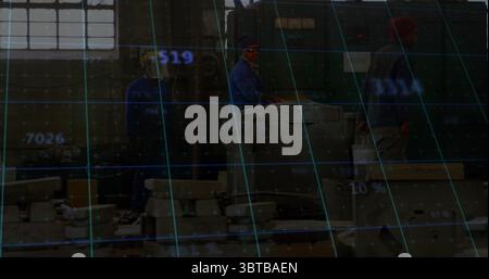 Operating lathe operator adjusting panel with colleague walking past workshop, digital grid overlay Stock Photo