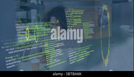 Typing developer wearing shirt, glasses at cafe patio, with laptop, coffee cup and code on glass Stock Photo