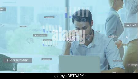 Rubbing stressed man in collared shirt working on laptop in modern office, with social media icons Stock Photo