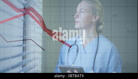 Holding tablet and gazing through clinic blinds with stethoscope, tracking trend lines, copy space Stock Photo
