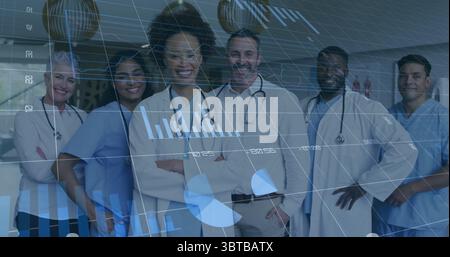 Standing medical team smiling in hospital corridor, with stethoscopes, scrubs and lab coats Stock Photo