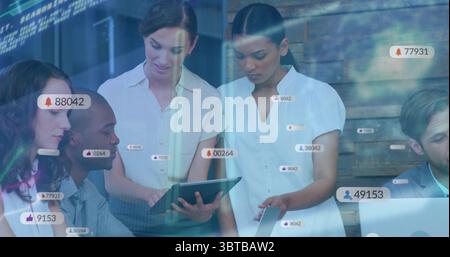 Collaborating colleagues reviewing project on tablet in conference room, with notification icons Stock Photo