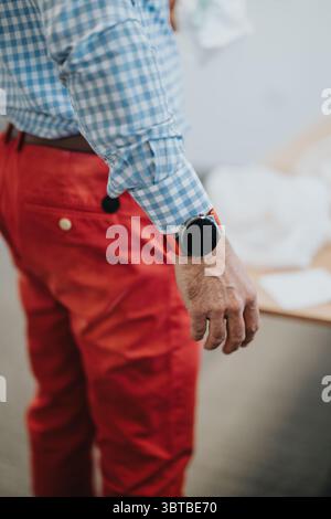 Business professional dressed sharply in colorful attire focusing on tasks Stock Photo
